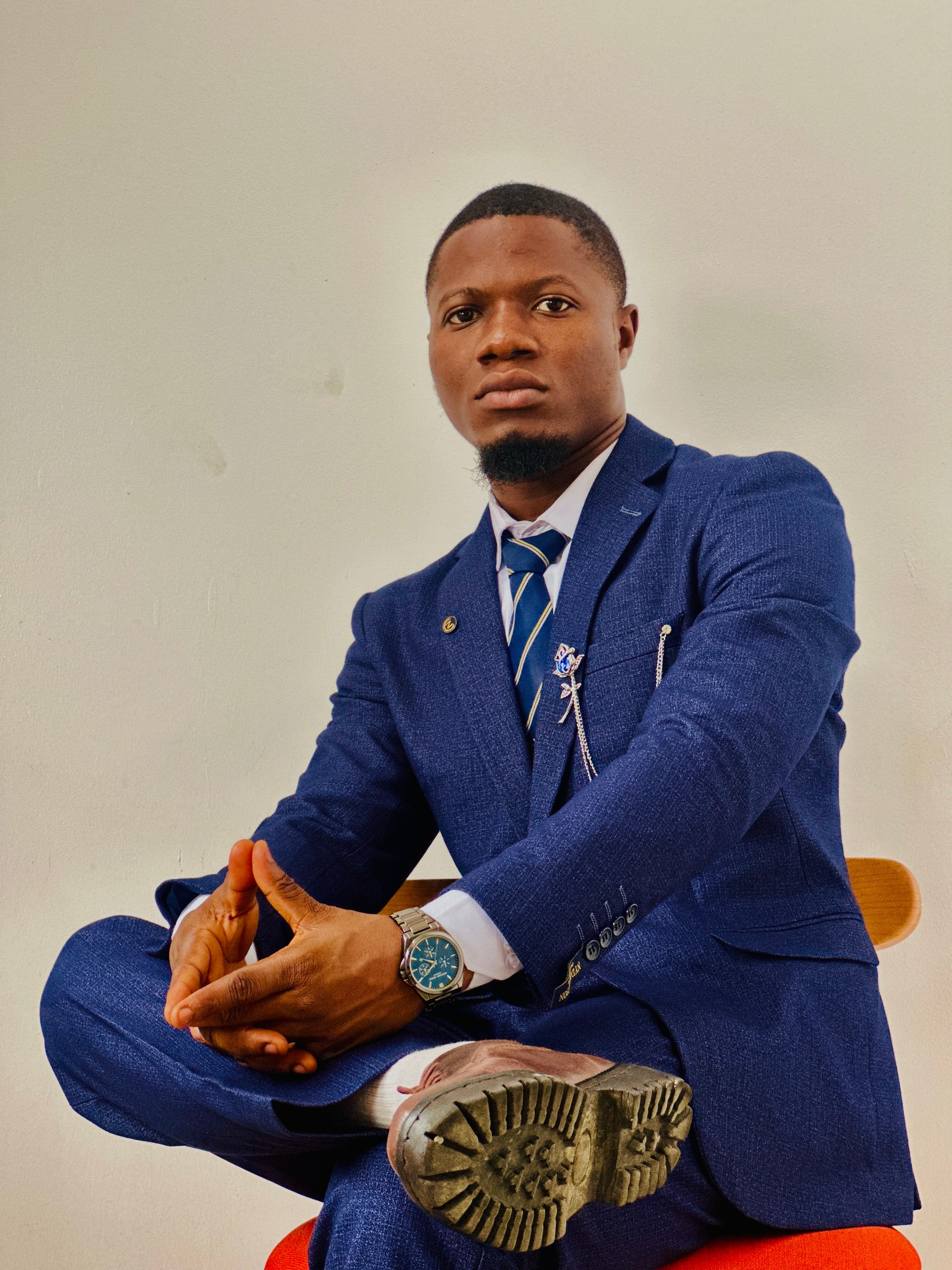 Ahmad in a navy suit, seated